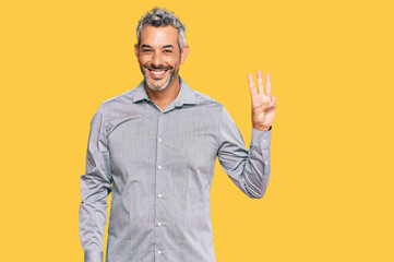 Middle age grey-haired man wearing casual clothes showing and pointing up with fingers number three while smiling confident and happy.