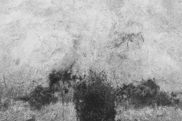 Old Wall for backgrounds. Old cement walls with black stains on the surface caused by moisture. Peeling wall surface with cracks and scratches, old rough gray cement wall surface for the background.
