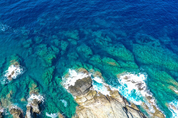 Fototapeta premium Aerial drone top view of beautiful sea waves and fantastic rocky coast. The concept of calmness, silence and unity with nature