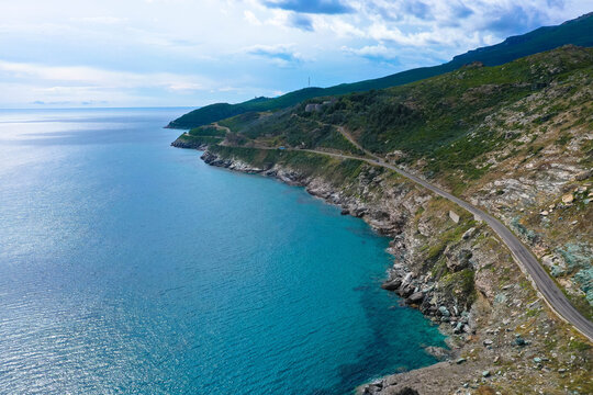Aerial view of the famous D80 road around Cap Corse peninsula, the important tourist path in Corsica Island, Haute-Corse, France. Tourism and vacations concept
