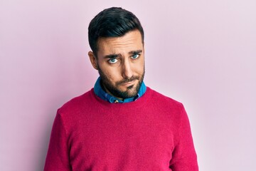 Young hispanic man wearing casual clothes skeptic and nervous, frowning upset because of problem. negative person.