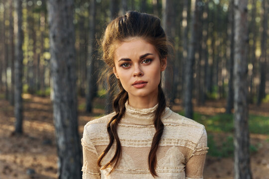 Portrait Of A Charming Lady In A Dress In The Forest And Trees Hairstyle Model