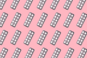 Seamless pattern of pills and tablets in packs on pink background. Medicine, pharmacy concept. Against diseases and coronavirus