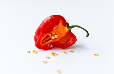 half cut habanero chilli pepper with seeds isolated with a white background