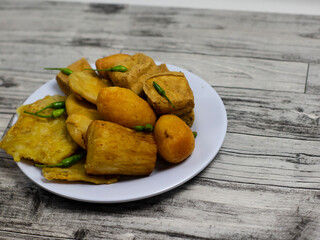gorengan fried food with chilies on top