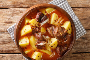 African style Lamb and potato stew with onions close-up in a bowl on the table. horizontal top view from above