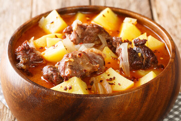 African style Lamb and potato stew with onions close-up in a bowl on the table. horizontal