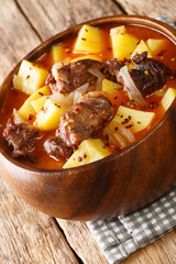 Bonava is a traditional lamb and potatoes stew from Mauritania closeup in a bowl on the table. Vertical