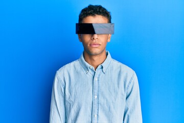 Obraz premium Young handsome african american man wearing banner glasses covering eyes thinking attitude and sober expression looking self confident
