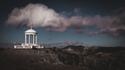 single white gazebo on the top of the mountain. place for meditation