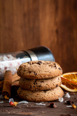 Organic food snack tasty sweet dessert milk dark chocolate chip salt cookie closeup piece fruit orange raspberry hazelnut nuts cinnamon on cocoa cacao powder wooden table for new year Christmas gift