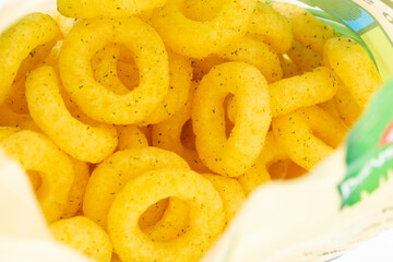 Beer snacks. Corn rings sticks with cheese and green onion flavor in the package close-up.