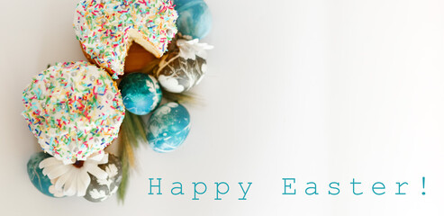 Easter cakes orthodox kulich and eggs and willow branches. Easter holiday scene. Festive composition on table