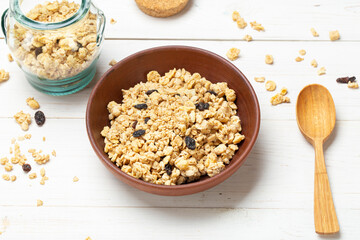Cereal. Breakfast with muesli and raisins on a white wooden table. Top view.