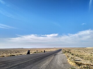 Freedom feeling riding the motorbike on an empty desert road in Turkmenistan