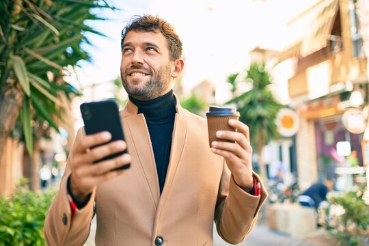 Handsome business man wearing elegant jacket using smartphone smiling happy outdoors