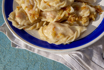 homemade dumplings with cabbage and fried onions. Russian kitchen.