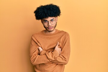 Obraz na płótnie Canvas Young african american man with afro hair wearing casual winter sweater skeptic and nervous, disapproving expression on face with crossed arms. negative person.