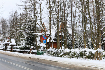 ZAKOPANE, POLAND - JANUARY 28, 2021: Streets and residential buildings in winter