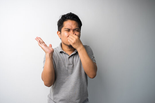 Man Closing Nose, Stink Face Expression. Isolated Portrait Selective Focus.