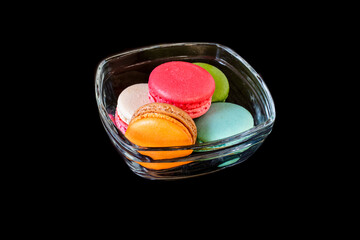 Colorful macarons dessert sweet for eat on glass bowl on black ,food and drink concept