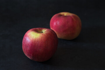Closeup shot of a fresh red apple with another apple in a blurred background