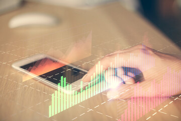 Double exposure of forex chart sketch hologram and woman holding and using a mobile device. Financial market concept.