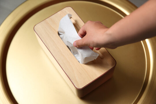 Woman Taking Paper Tissue Out Of Box On Table, Above View