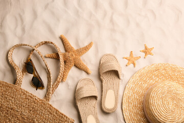 Different beach accessories on sand, flat lay