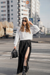 Obraz premium Girl with white hoodie and black skirt crossing street