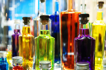 Glass bottles with multi-colored alcohol. Close-up