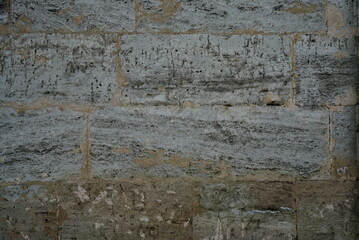 Old grey limestone blocks wall background texture