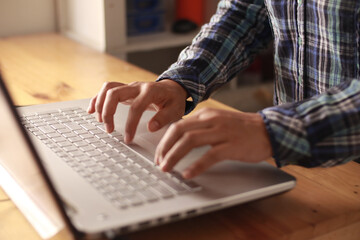 Close up of person fingers typing on laptop, business or education