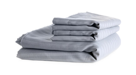 Stack of clean bed sheets isolated on white