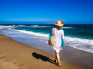 Middle-aged woman walking on beach
