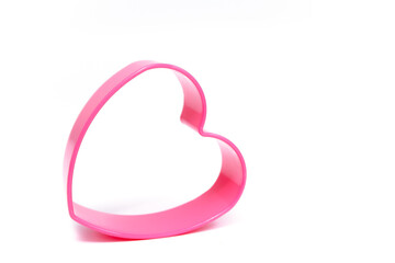 Plastic pink mold for making cookies in the shape of a heart