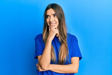 Young hispanic woman wearing casual clothes with hand on chin thinking about question, pensive expression. smiling with thoughtful face. doubt concept.