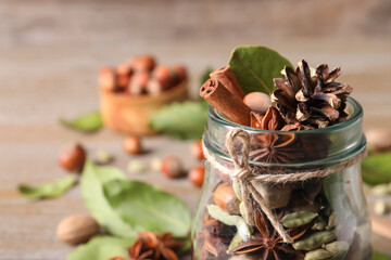Aromatic potpourri in glass jar on table, closeup. Space for text