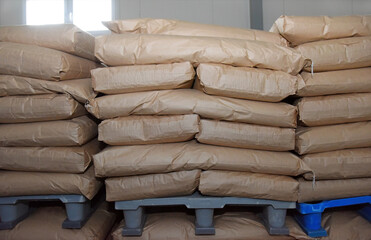 Close-up of bags of sugar and flour in the warehouse of the processing plant, the products are ready for further use.