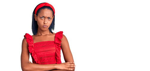 Young african american woman wearing casual summer clothes skeptic and nervous, disapproving expression on face with crossed arms. negative person.
