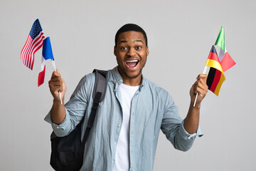 Emotional black man with backpack showing diverse flags