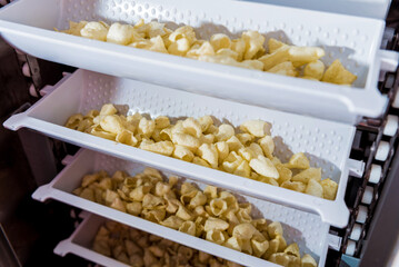 Conveyor line for packing snacks and chips in a modern factory