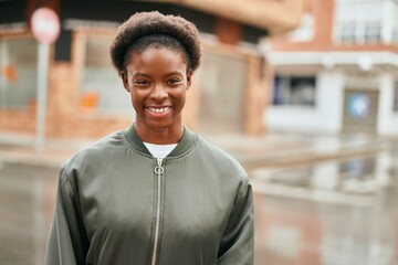 Young african american girl smiling happy standing at the city.