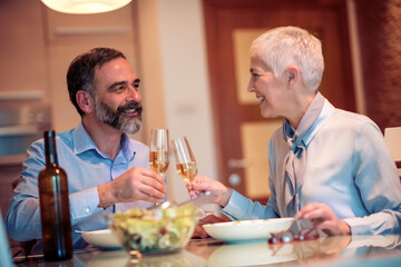 Senior couple drink wine at home