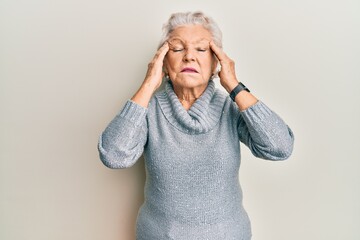 Senior grey-haired woman wearing casual clothes with hand on head, headache because stress. suffering migraine.