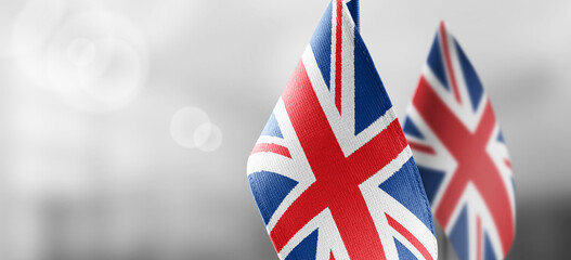 Small national flags of the United Kingdom on a light blurry background