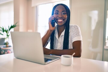 Young african american woman smiling happy working using laptop at home