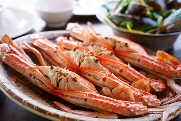 steamed blue crab or horse crab in dish and baked mussels in pot on wood table for delicious fresh seafood to breakfast or lunch and dinner with have iodine and cholesterol in food at restaurant