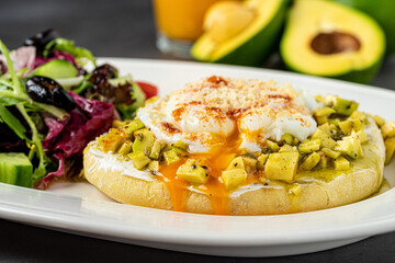 Avocado Sandwich with Poached Egg. Chopped avocado and egg on toasted bread for healthy breakfast or snack.