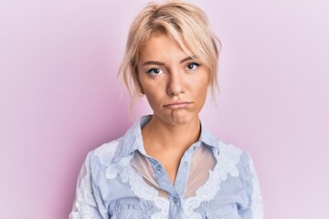 Young blonde girl wearing casual clothes depressed and worry for distress, crying angry and afraid. sad expression.